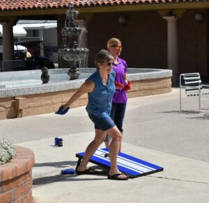 A woman playing Cornhole