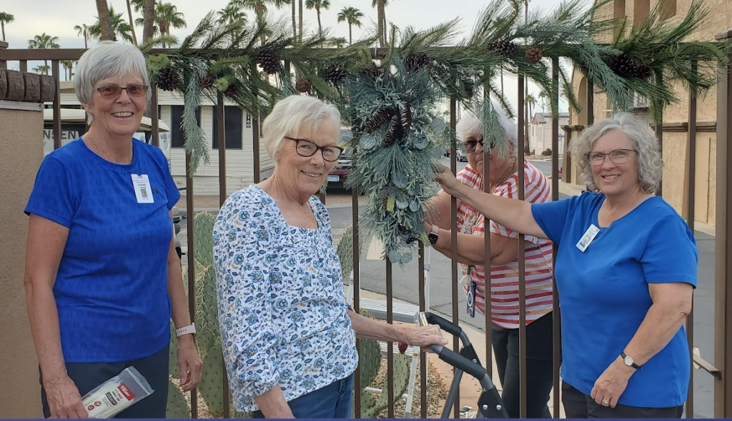 Residents posing in front of newly decorated gate.